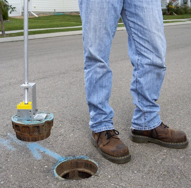 Magswitch magnetic lifter removing a metal utility cover from a street