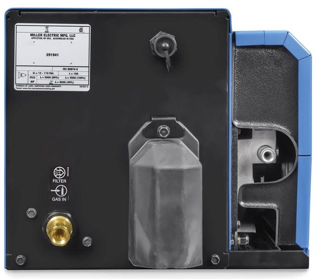 Rear view of Miller welding equipment showing gas inlet and technical specification label
