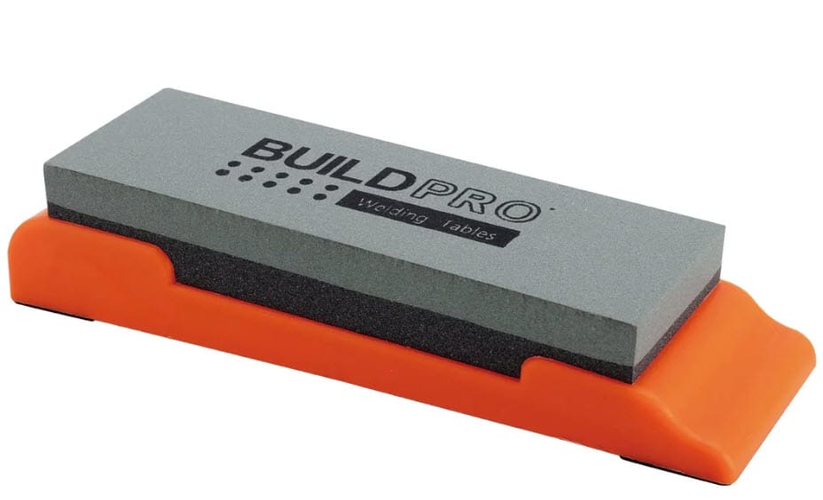 BuildPro rectangular abrasive cleaning block in an orange plastic holder
