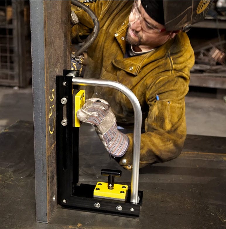 Worker using a Magswitch magnetic square to hold steel beams in place