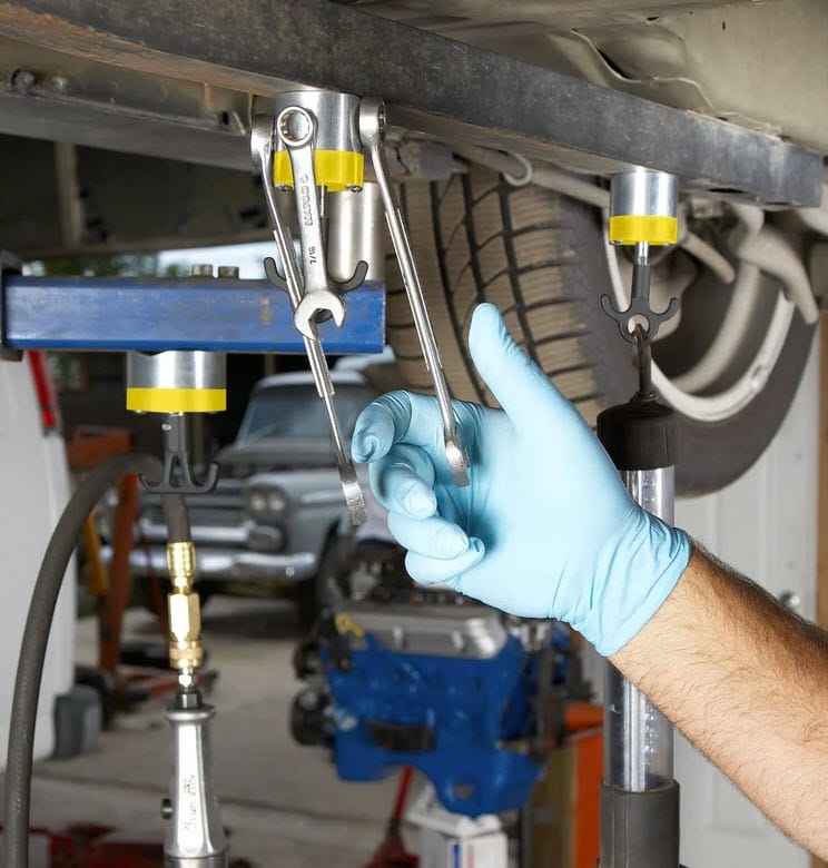 Magswitch magnetic tool hooks holding wrenches on a metal vehicle frame