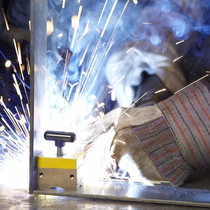 Magswitch magnetic welding square holding metal plates during a welding operation with sparks