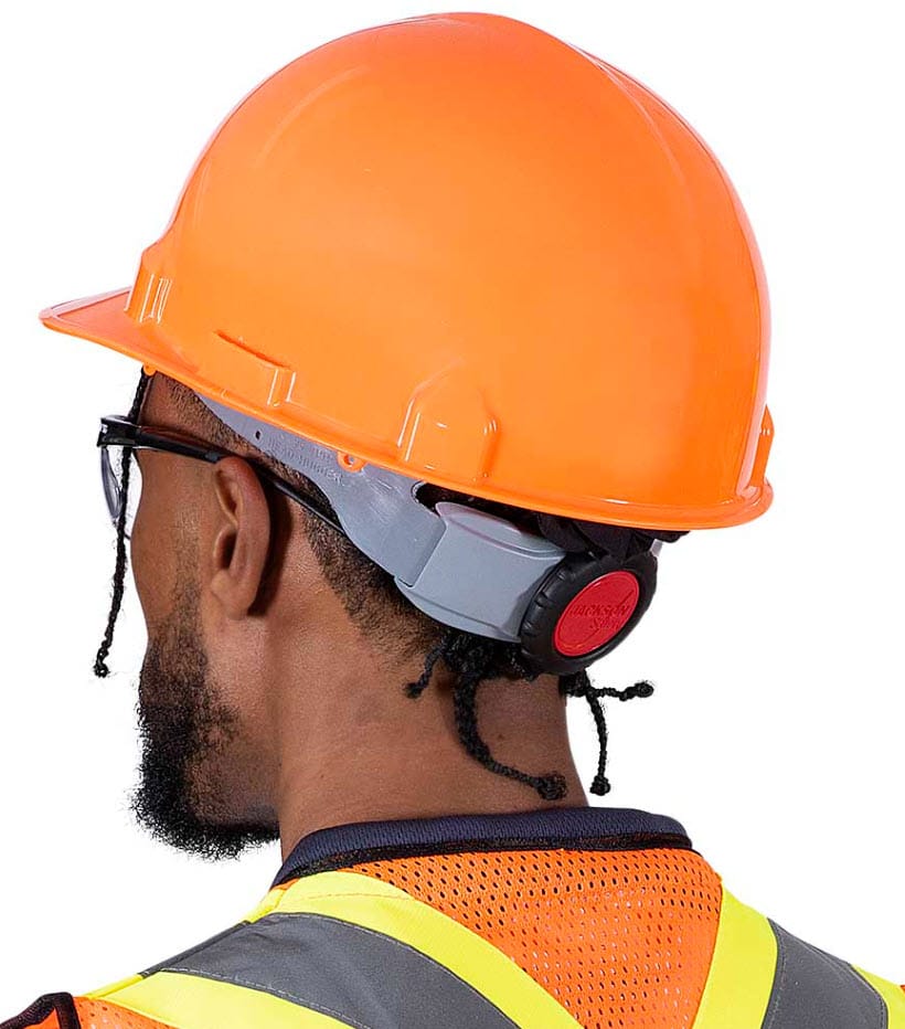 Person wearing a Jackson Safety orange hard hat with adjustable ratchet suspension