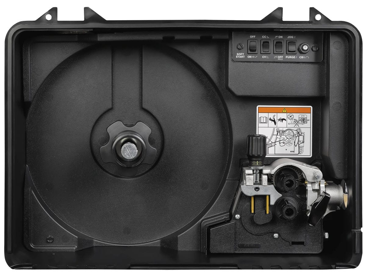 Internal wire feed mechanism of a welding machine with control switches and instructional diagram